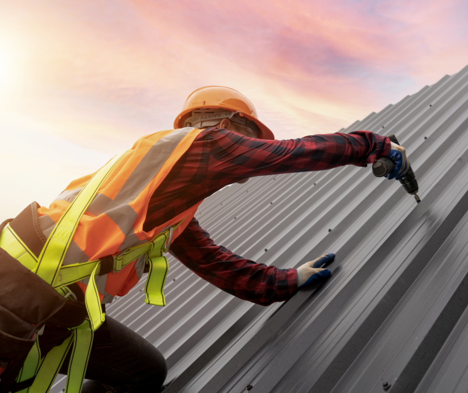 Man on working on roof in high-vis
